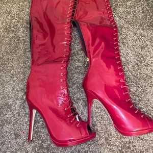 Red lace up knee high latex boots